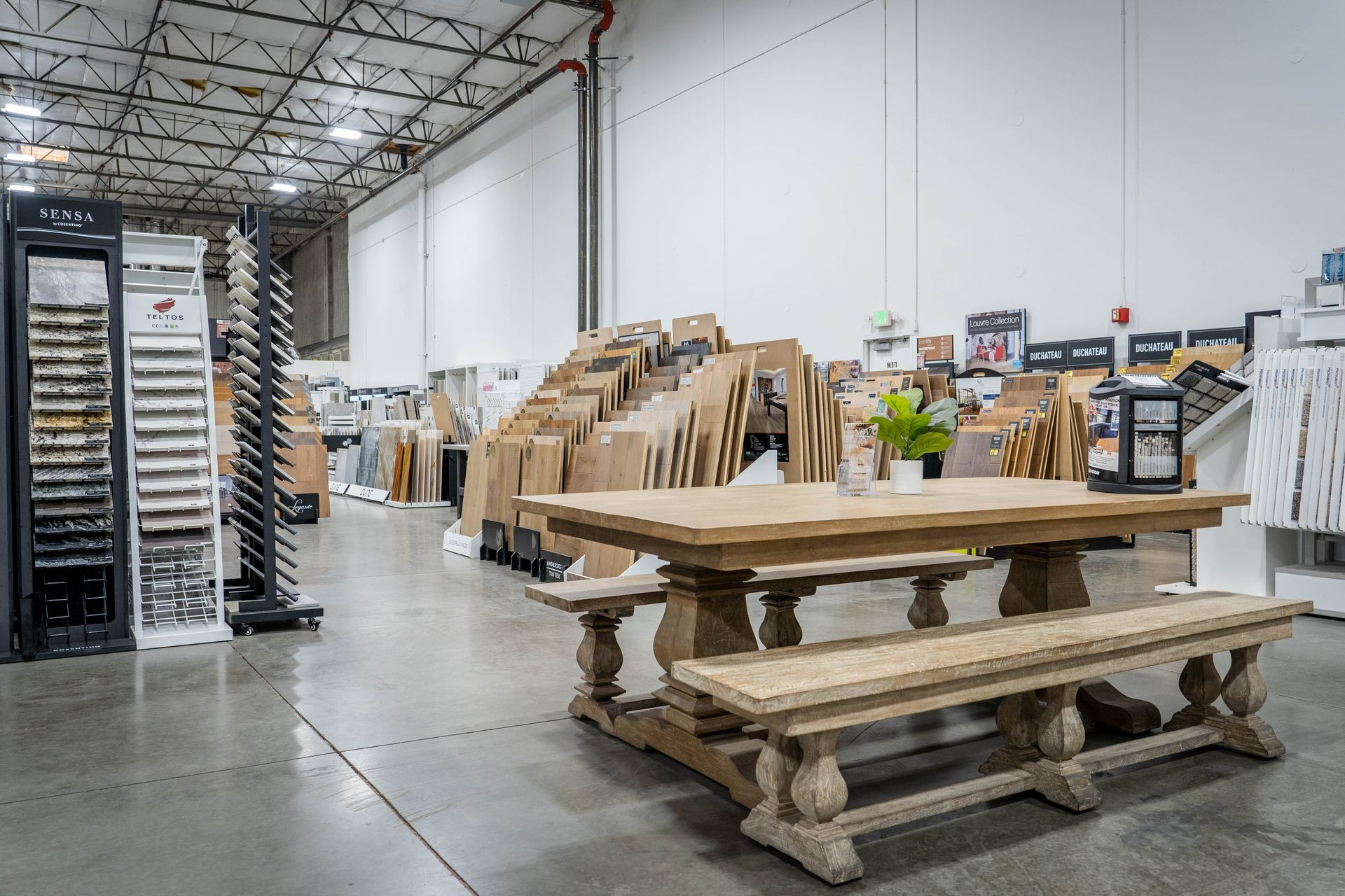 Nova Tile and Stone Reno showroom with rustic wood consultation table and tile displays