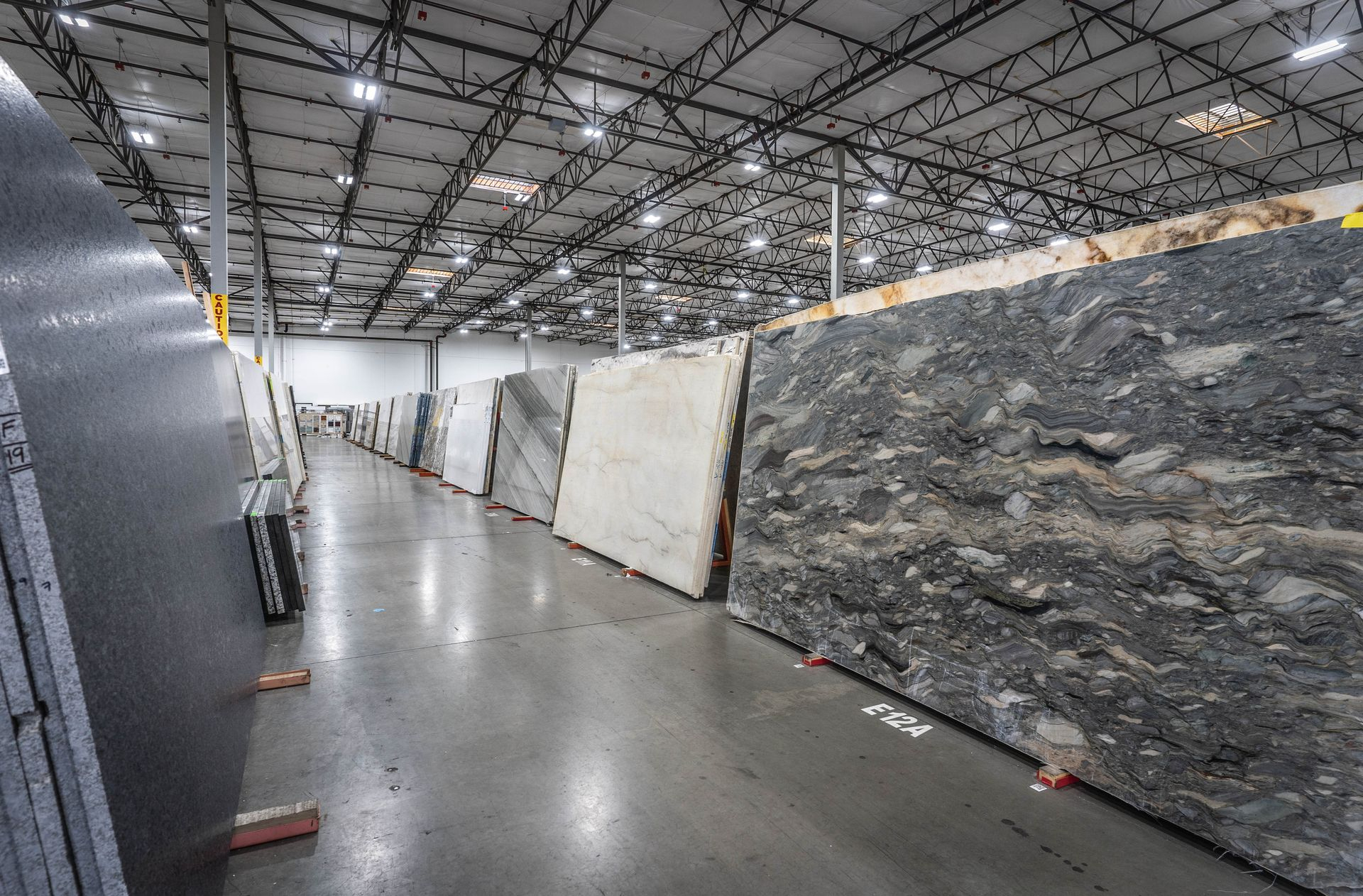 Dramatic grey and black natural stone countertop slabs at Nova Tile Reno slab yard