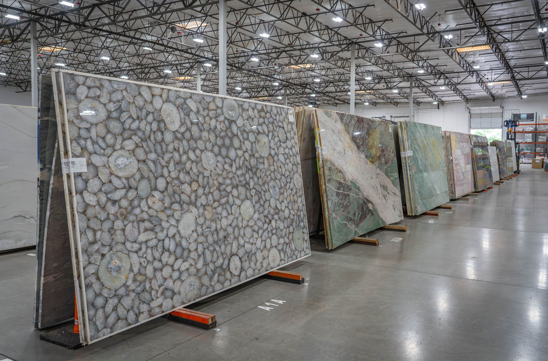 Natural stone slabs including pebble stone and marble on display at Nova Tile Reno