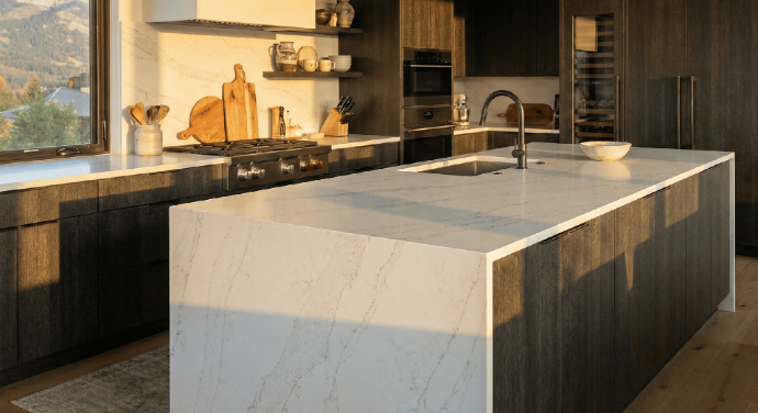 A modern kitchen featuring a sleek central island with a porcelain slab countertop.