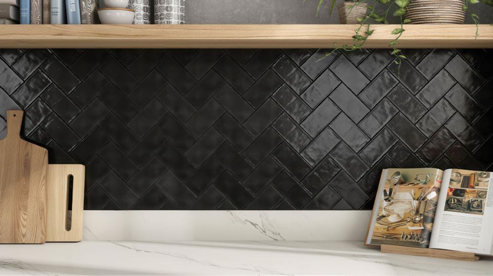 Kitchen backsplash with glossy black herringbone tiles