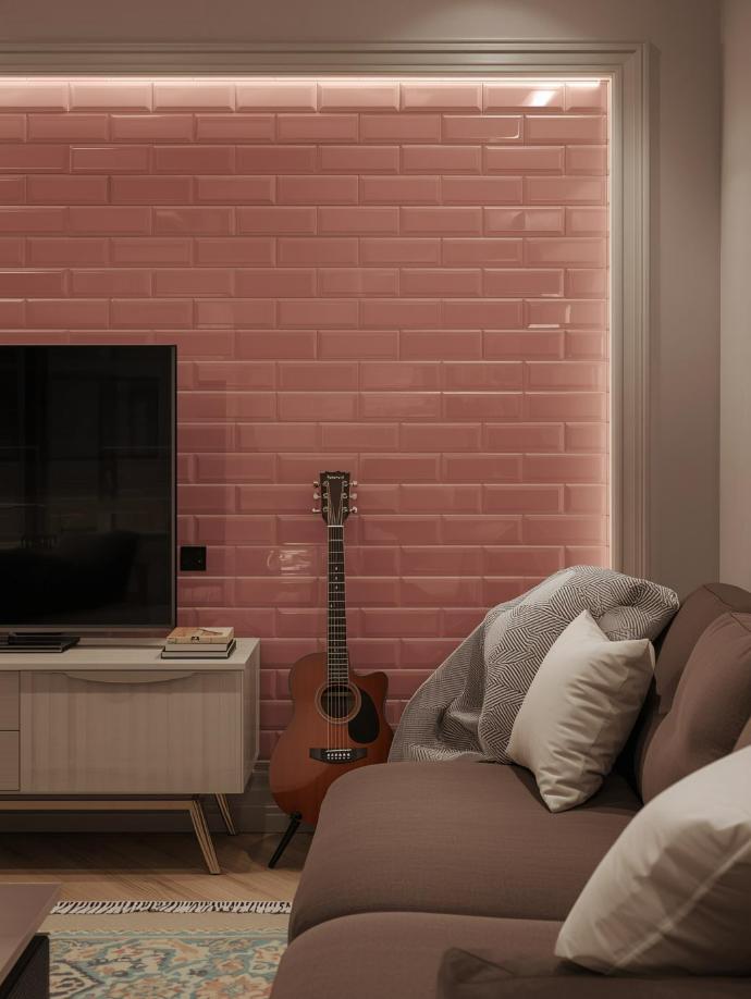 A living room accent wall featuring glossy 3x6 pink subway tiles, shown behind a brown sofa and an acoustic guitar.
