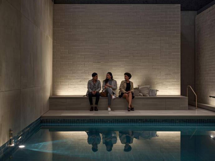 cement look subway tiles in swimming pool with 3 people