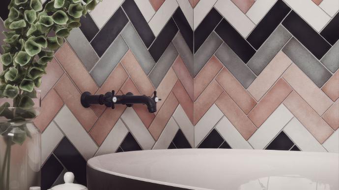Bathroom with freestanding tub and black fixtures, featuring a herringbone wall pattern of multi-colored Perfection 2.5x8 Matte Porcelain Subway Tile.