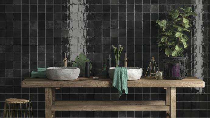 Bathroom vanity with two stone vessel sinks and a dark wall covered in Odyssey nero 5x5 wall mid-century look porcelain tile.