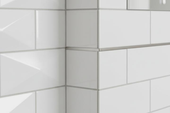 Close-up comparison showing beveled subway tile angled chamfer next to flat edge flush transition