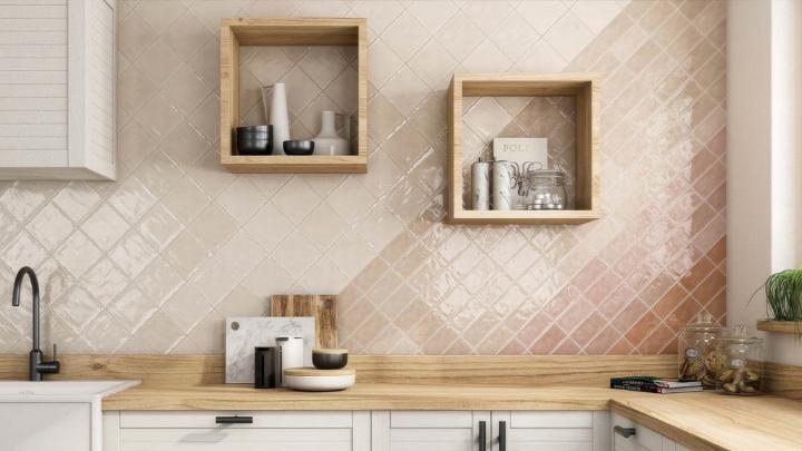 Warm kitchen with a cream and blush pink diamond-shaped subway tile backsplash, wood countertops, and white cabinets.