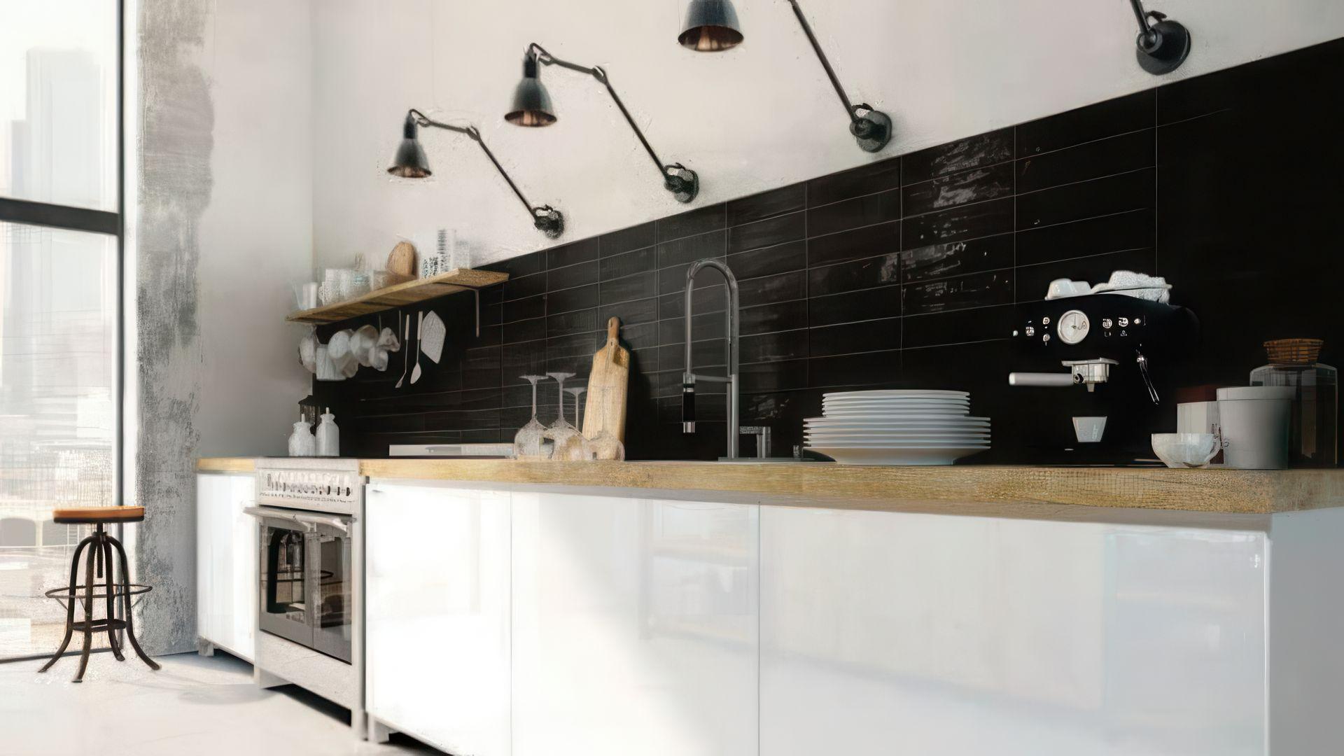 Modern industrial kitchen with black subway tile backsplash and white cabinets