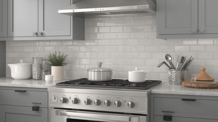 Modern kitchen with light gray shaker cabinets, stainless steel appliances, and a white glossy subway tile backsplash.