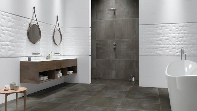 Modern bathroom with large format subway tile in the dark gray walk-in shower, a floating wood vanity, and a freestanding tub.