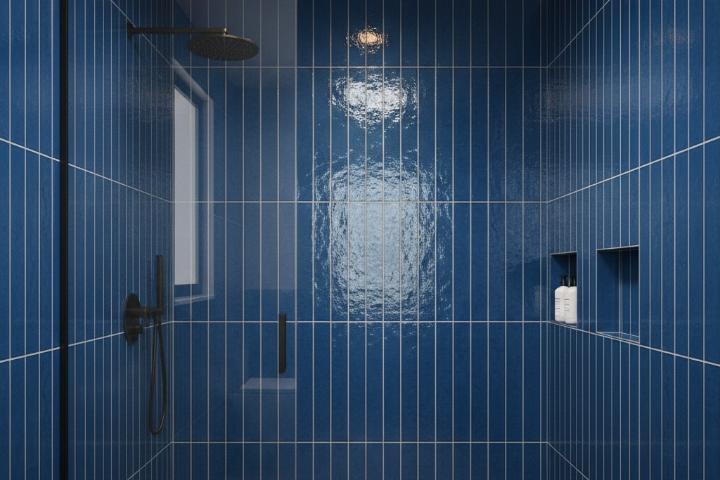 Blue glossy subway tiles arranged vertically in shower enclosure