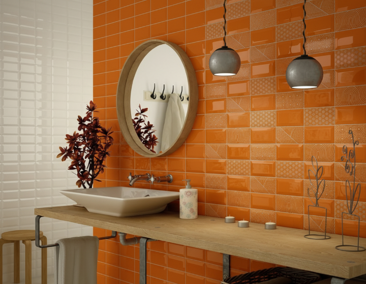 Bathroom with vibrant orange 3x6 subway tile backsplash, modern round mirror, vessel sink, and hanging pendant lights.