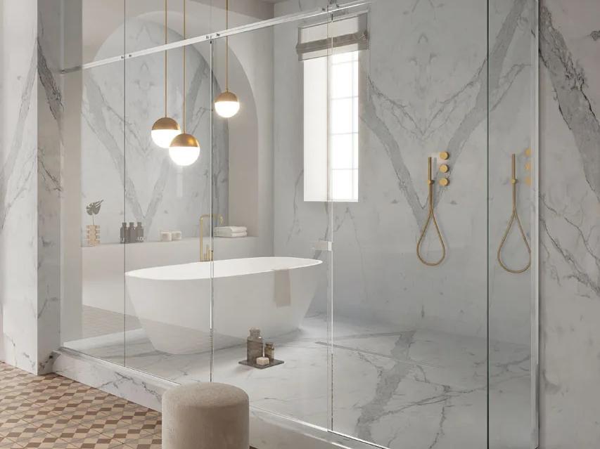 Statuario Principe porcelain slabs covering full bathroom walls with gold shower fixtures