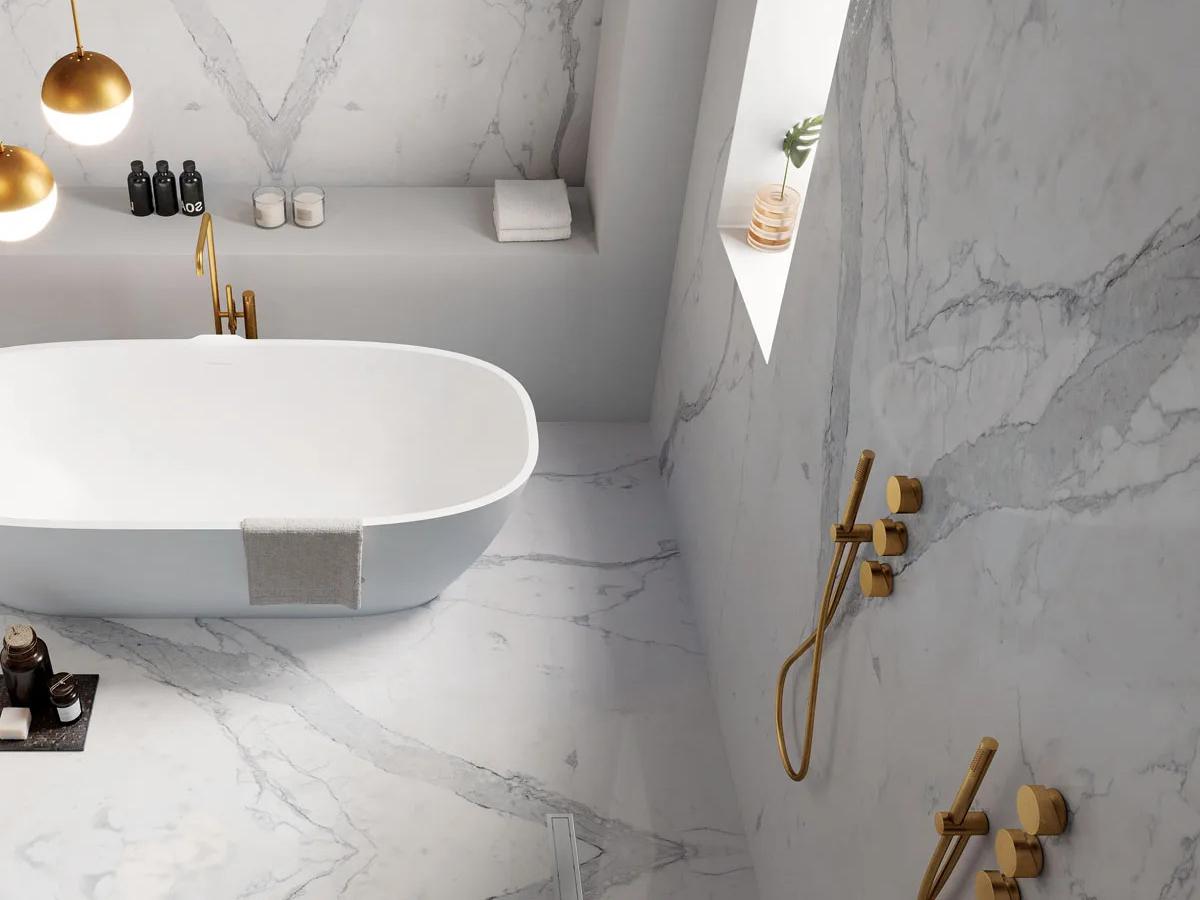 Statuario Principe porcelain slabs covering bathroom walls with a freestanding white tub