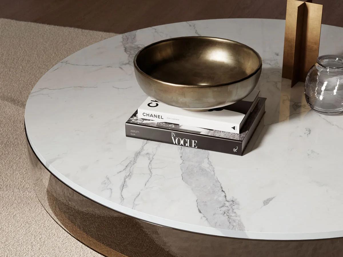 Statuario Principe porcelain slabs round table surface with Vogue magazine and gold bowl