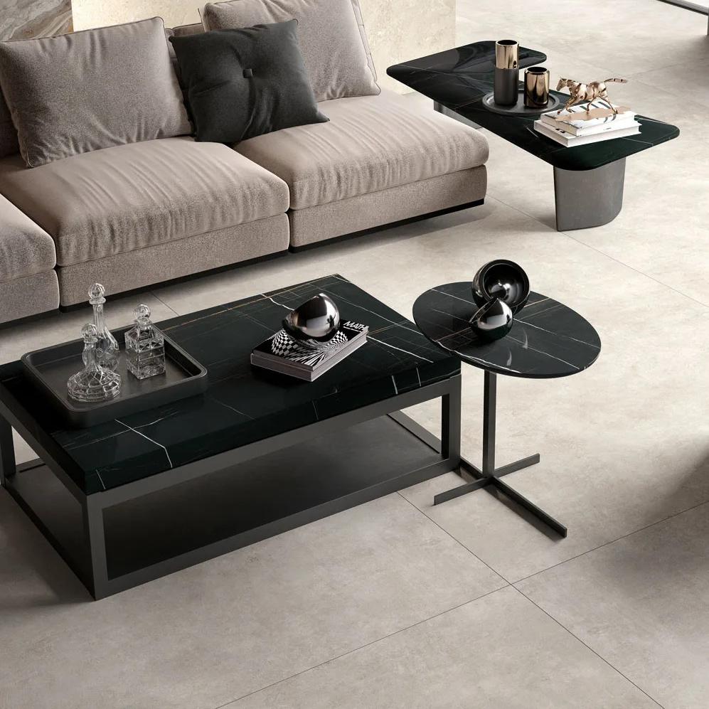 Modern living room with Sahara Noir porcelain slabs coffee table and neutral toned sofa.