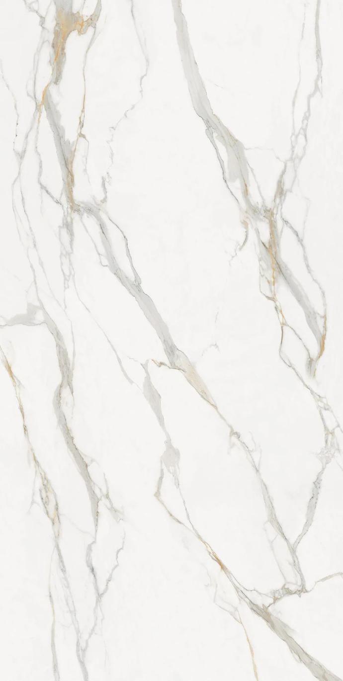 Calacatta Oro porcelain slabs surface detail showing soft grey veins with warm golden accent tones.