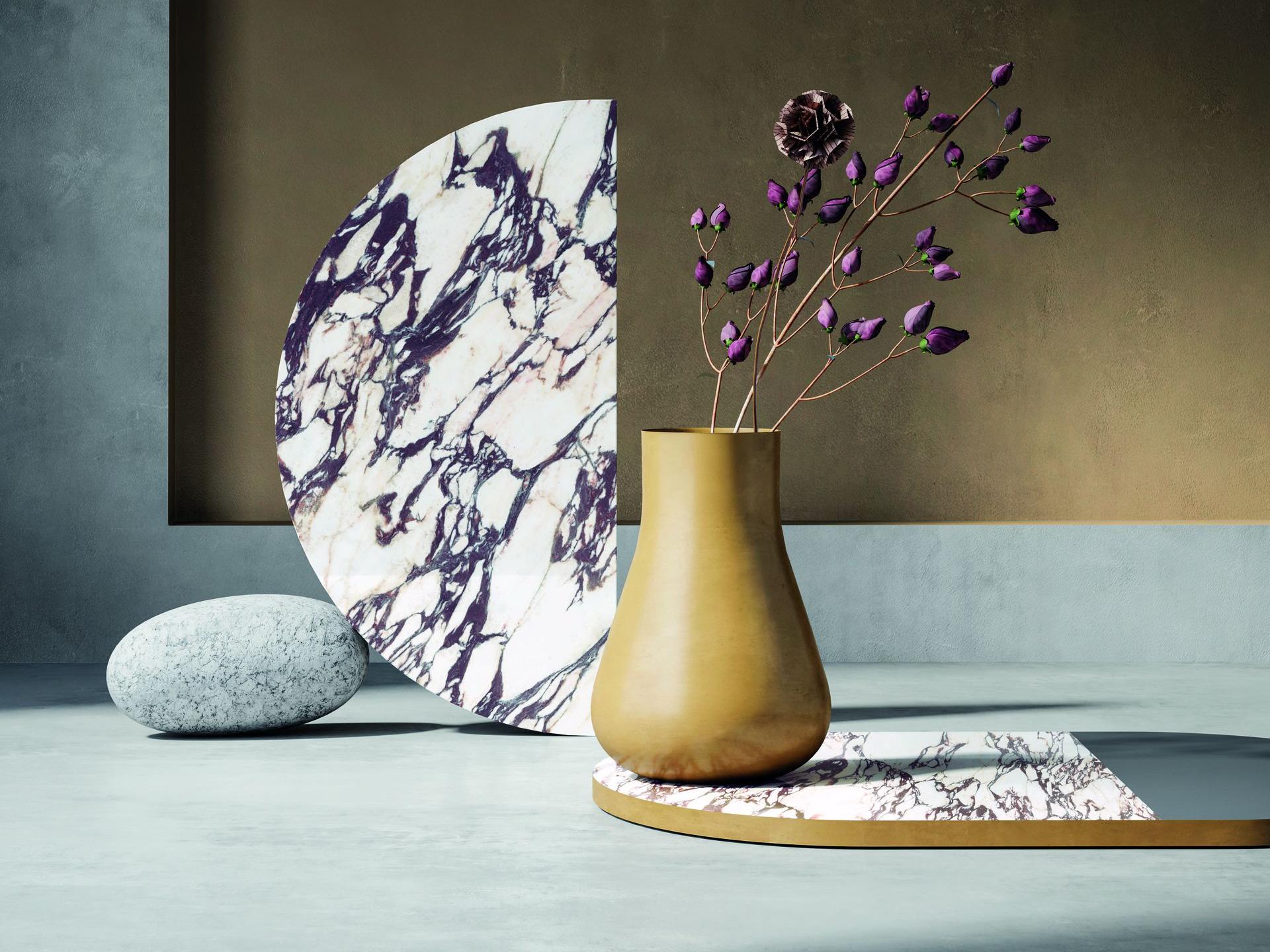 Decorative display of Calacatta Viola porcelain slabs sample with purple flowers arrangement.