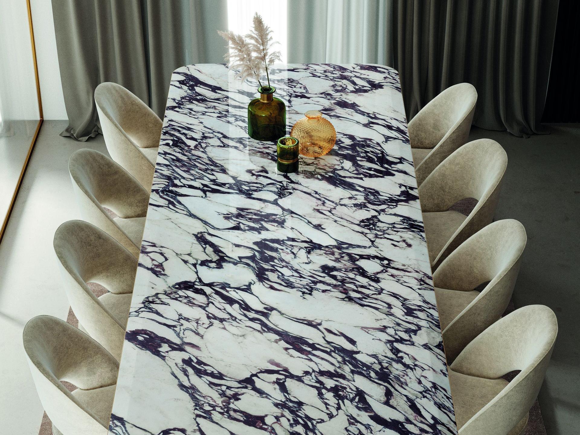 Dining table made from Calacatta Viola porcelain slabs surrounded by white chairs.