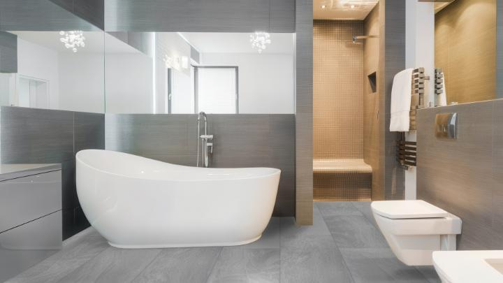 Modern bathroom with a freestanding bathtub, walk-in shower, and walls finished in slate look subway tile for a sleek, contemporary design.