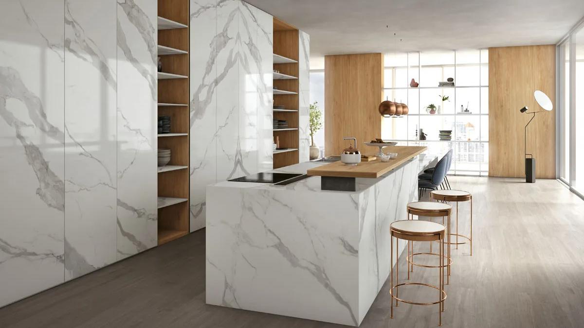 Modern kitchen with Classic Statuario porcelain slabs on island walls and countertop with wood shelving.