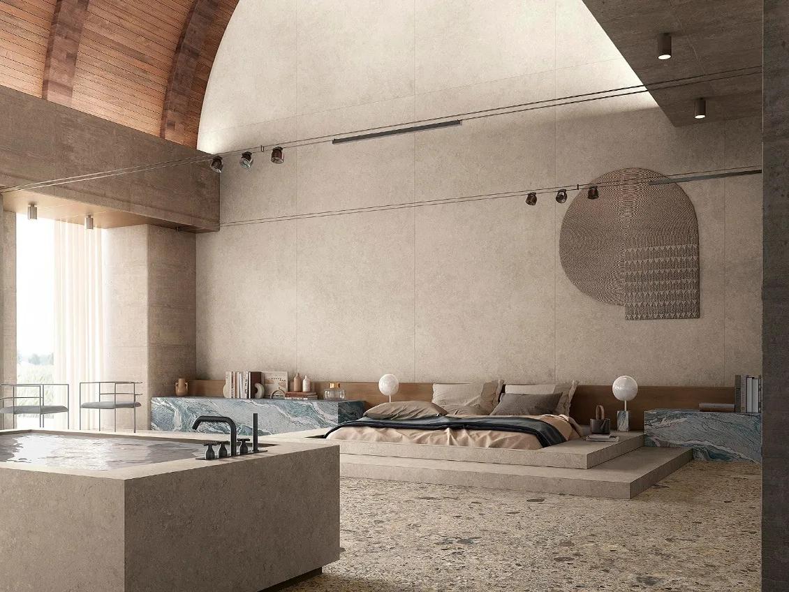 Minimalist bedroom featuring Ceppo Romano porcelain slabs on platform bed frame with arched wood ceiling.