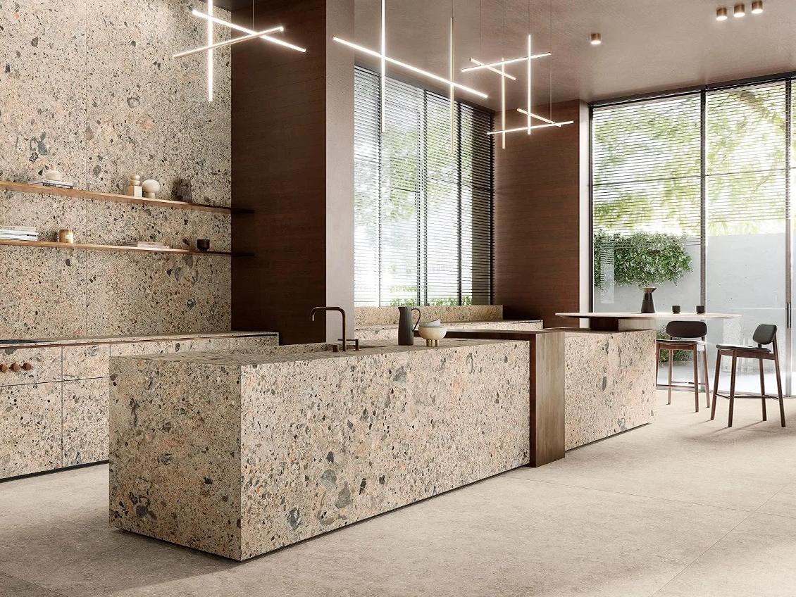 Modern retail space with Ceppo Romano porcelain slabs on reception counter and geometric pendant lighting.