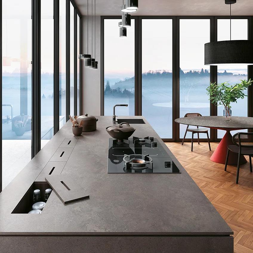 Modern kitchen with Buxy Select porcelain slabs countertop island and scenic sunset window view.