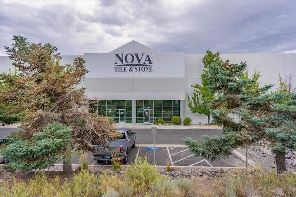 Nova Tile and Stone Company showroom exterior with modern building and landscaped parking area.
