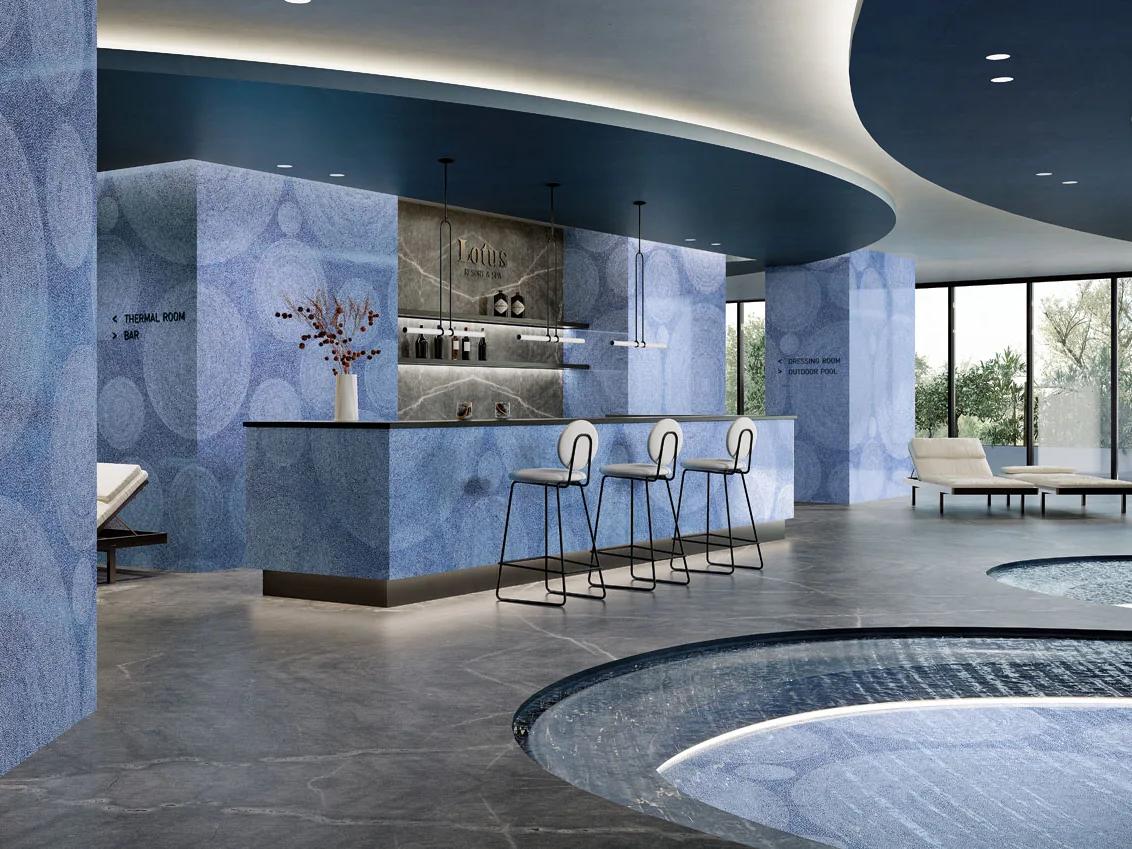 Modern kitchen featuring Holos Aegean Blue Porcelain Slabs on walls and island surfaces.