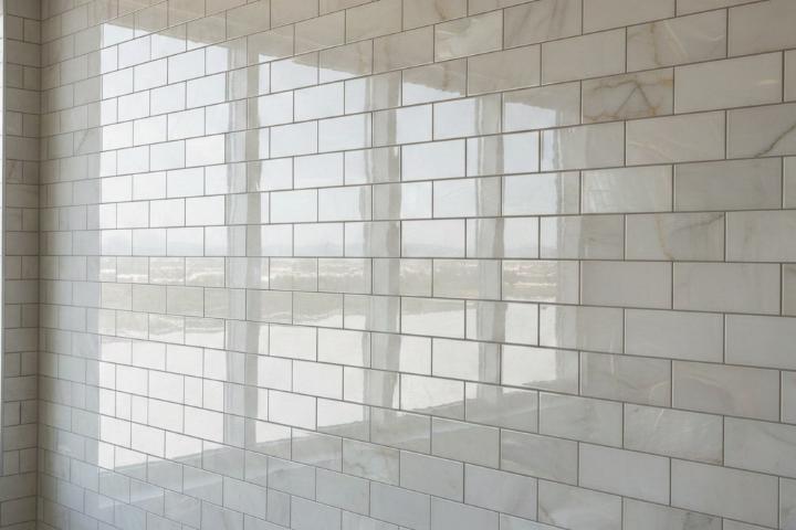 Glossy marble-effect subway tiles reflecting natural light