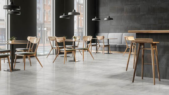 Cascade Pearl 12x24 metallic look porcelain tile - commercial café installation showing light pearl-grey oxidized finish ideal for high-traffic restaurant and retail spaces