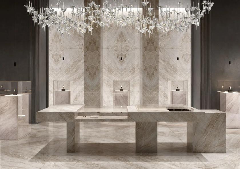 Taj Mahal porcelain slabs covering full walls and floors in a luxury chandelier-lit space