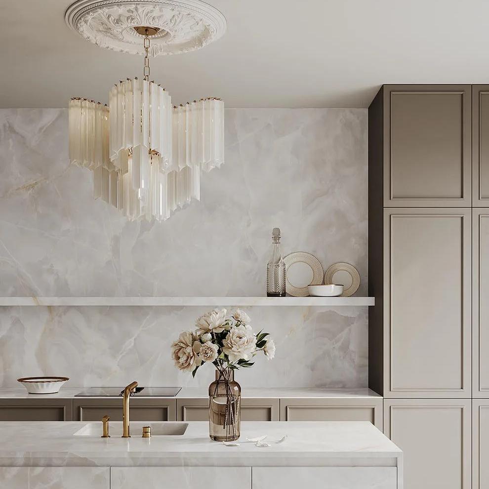 Luxurious kitchen design showcasing Onyx White porcelain slabs with decorative chandelier and countertops.