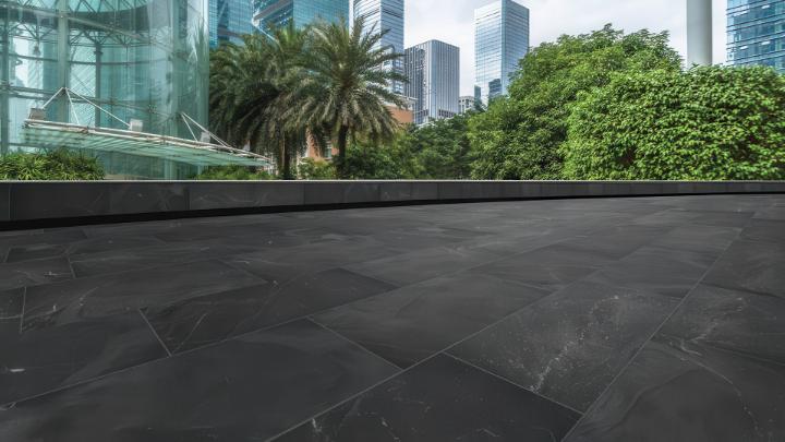 Contemporary slate look porcelain tile installed in an urban outdoor plaza.