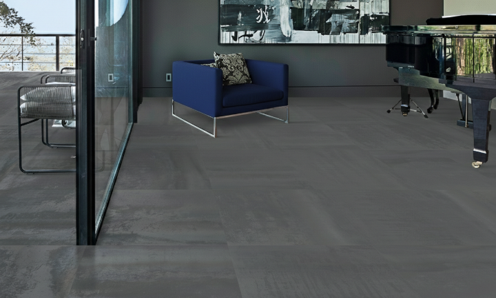Contemporary workspace featuring charcoal porcelain tile floors and blue accent seating Modern office with dark gray porcelain tile flooring
