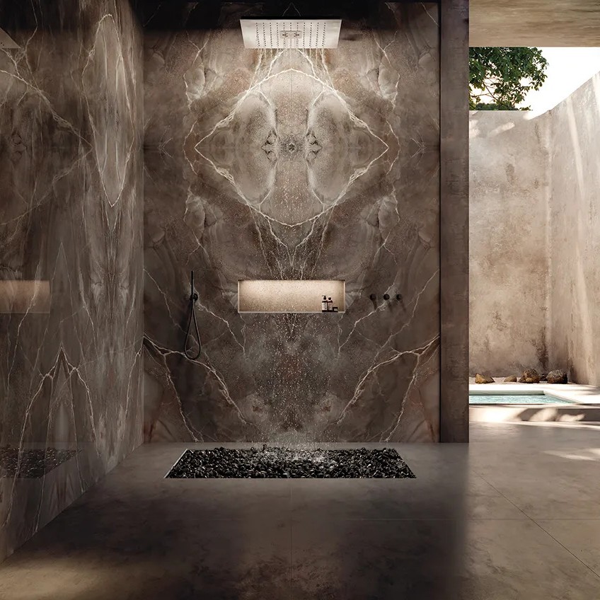 Luxury shower design featuring Andromeda porcelain slabs on walls with rain showerhead.