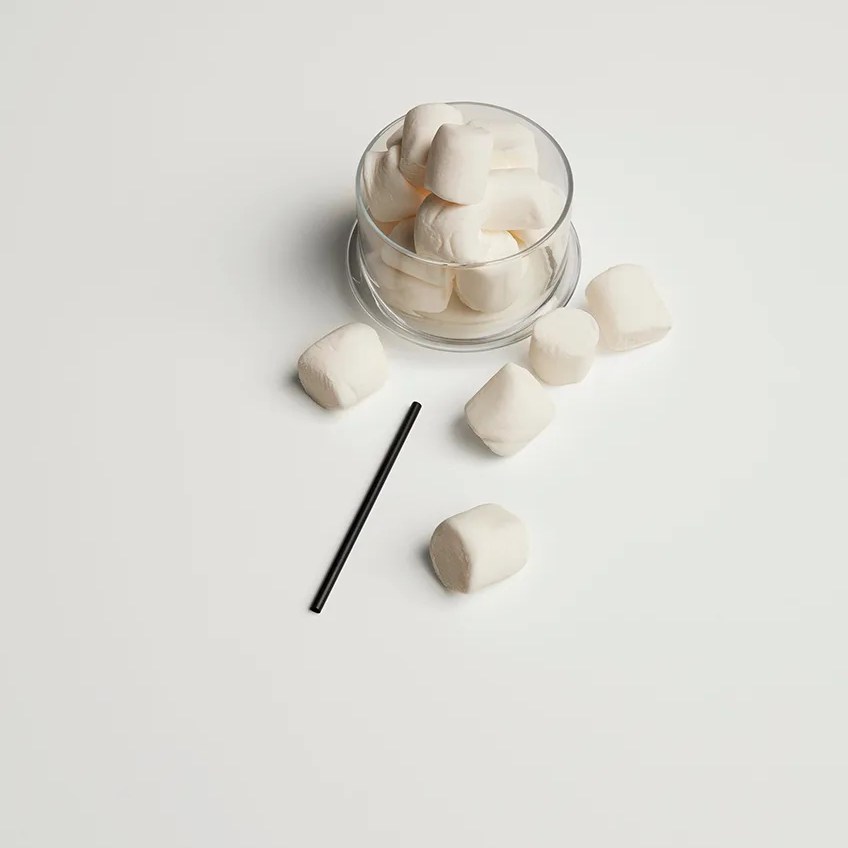 White sugar cubes and straw showing the pristine finish of Absolute White porcelain slabs.