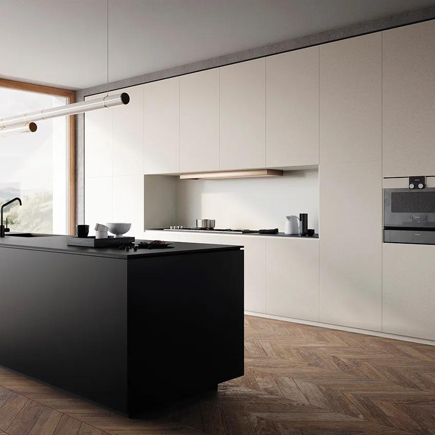 Modern minimalist kitchen with matte black island against Absolute White porcelain slabs backdrop.