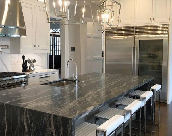 Modern kitchen island topped with dramatic dark quartzite stone.