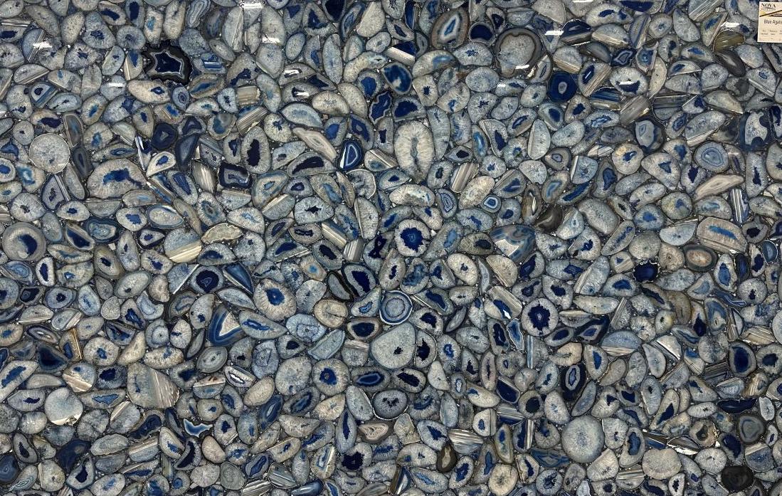 A large semi-precious Blue Agate slab featuring a dense mosaic of polished blue and light grey geode slices.