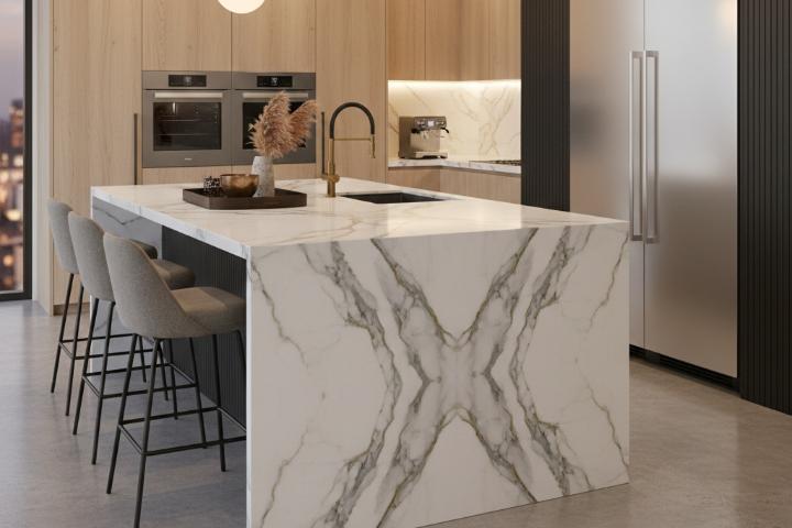 Waterfall edge kitchen island featuring book-matched natural stone slabs