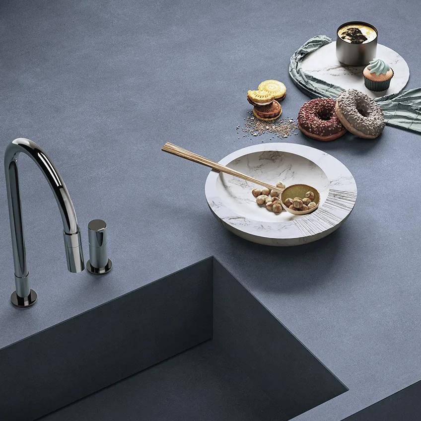 Modern kitchen sink installed on Antibes porcelain slabs countertop with black faucet fixture.