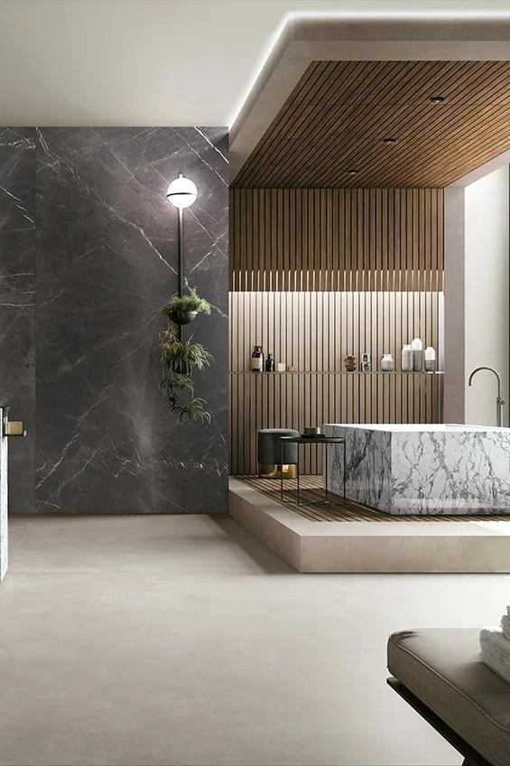 Luxury bathroom with dark marble walls and wood ceiling featuring porcelain slab surfaces.