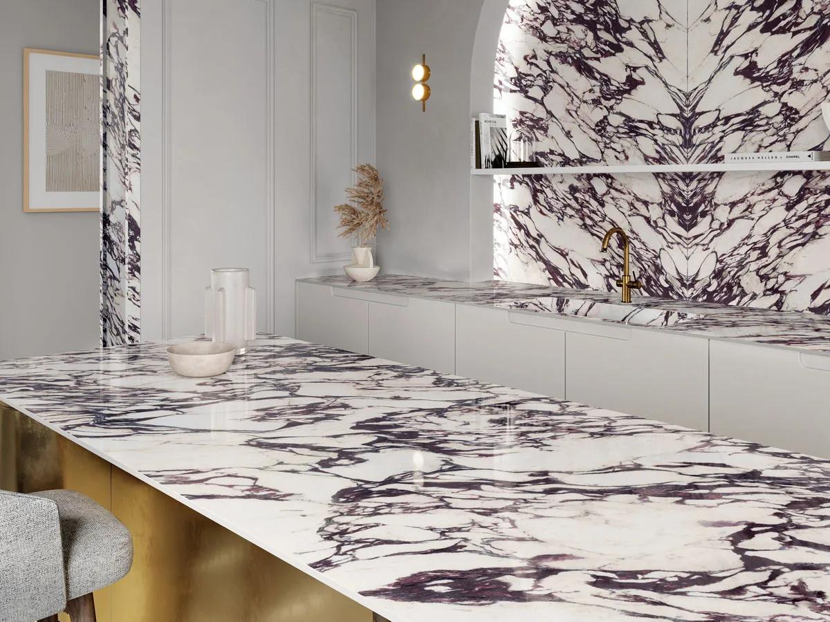 Calacatta Viola porcelain slabs installed as bathroom vanity with book-matched wall panels.