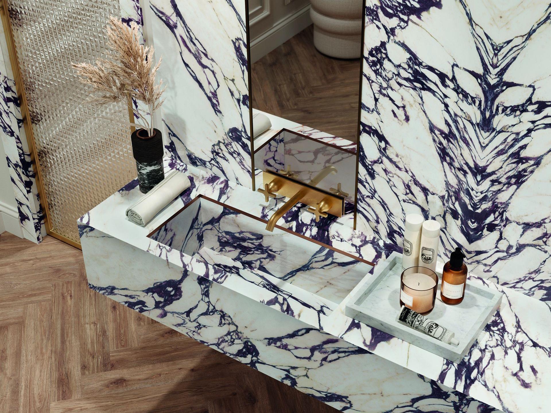 Living space featuring Calacatta Viola porcelain slabs as statement fireplace wall cladding.