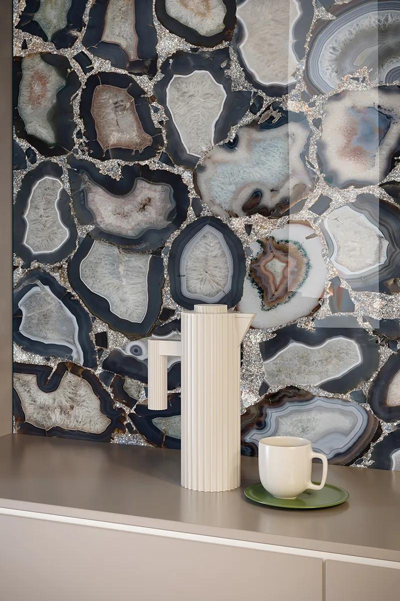 Cammeo porcelain slabs used as a feature wall behind a shelf with white ceramic vases.