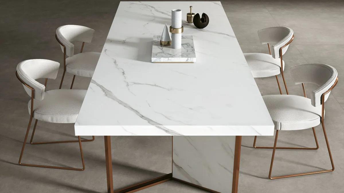 Elegant dining table crafted from Extra Statuario porcelain slabs with gold chair accents