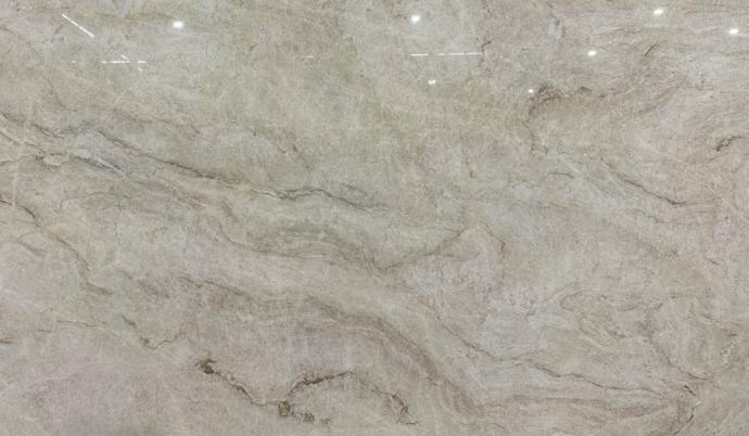 Polished Taj Mahal quartzite slab with warm ivory base and flowing taupe veining at Nova Tile and Stone Sacramento
