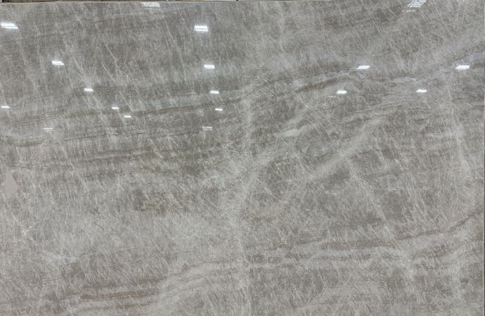 Polished Taj Mahal quartzite slab with deep gray base and layered veining at Nova Tile and Stone Reno